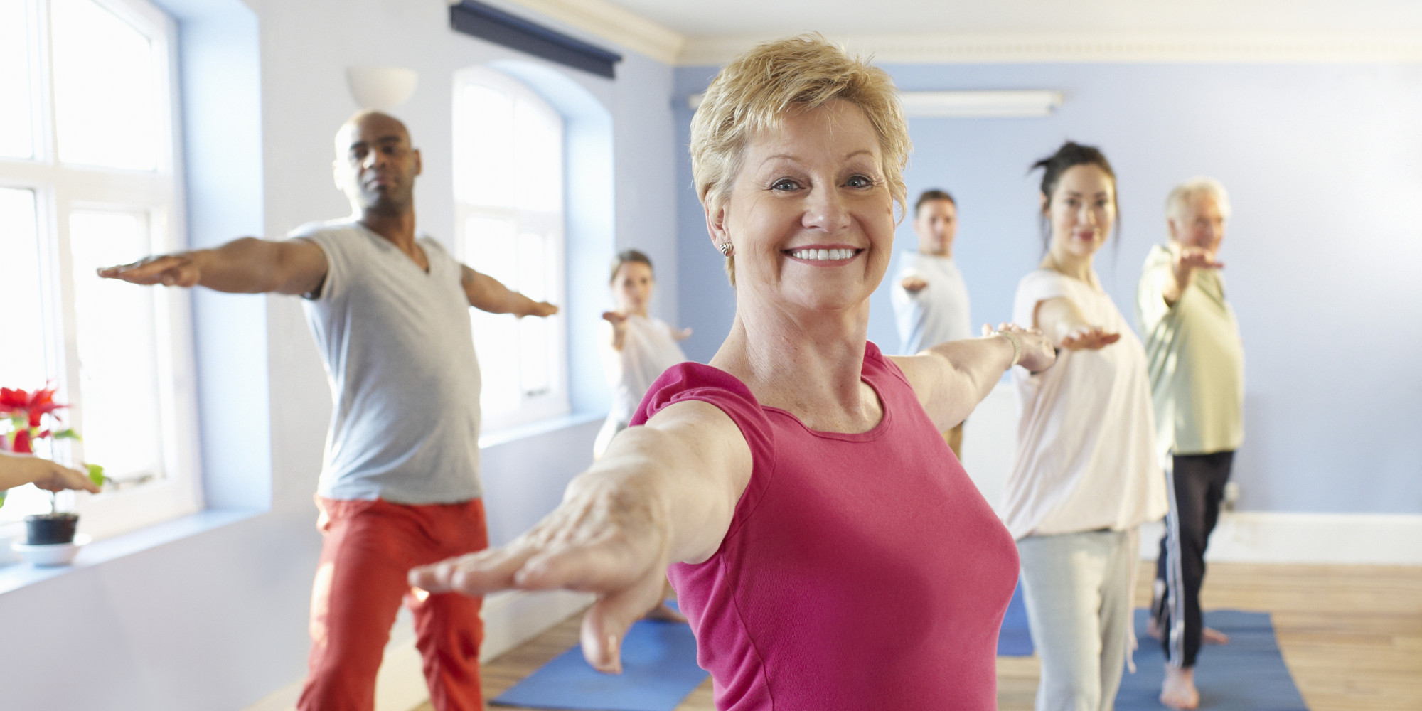 Mature woman at front of exercise class