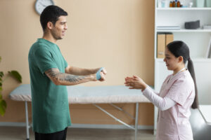 Physiotherapist helping patient recover from car accident injuries with hands-on therapy in Ottawa