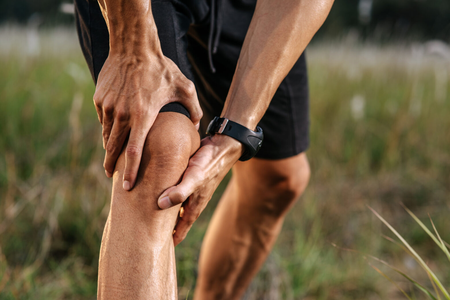 Individual experiencing knee pain with highlighted joint area showing inflammation and discomfort