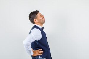 Physiotherapist assessing a patient with middle back pain on the right side in Barrhaven, Ottawa