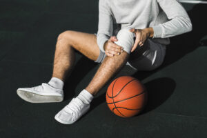 Physiotherapist assessing an athlete's knee during sports injury treatment at Care2Cure Physiotherapy in Ottawa
